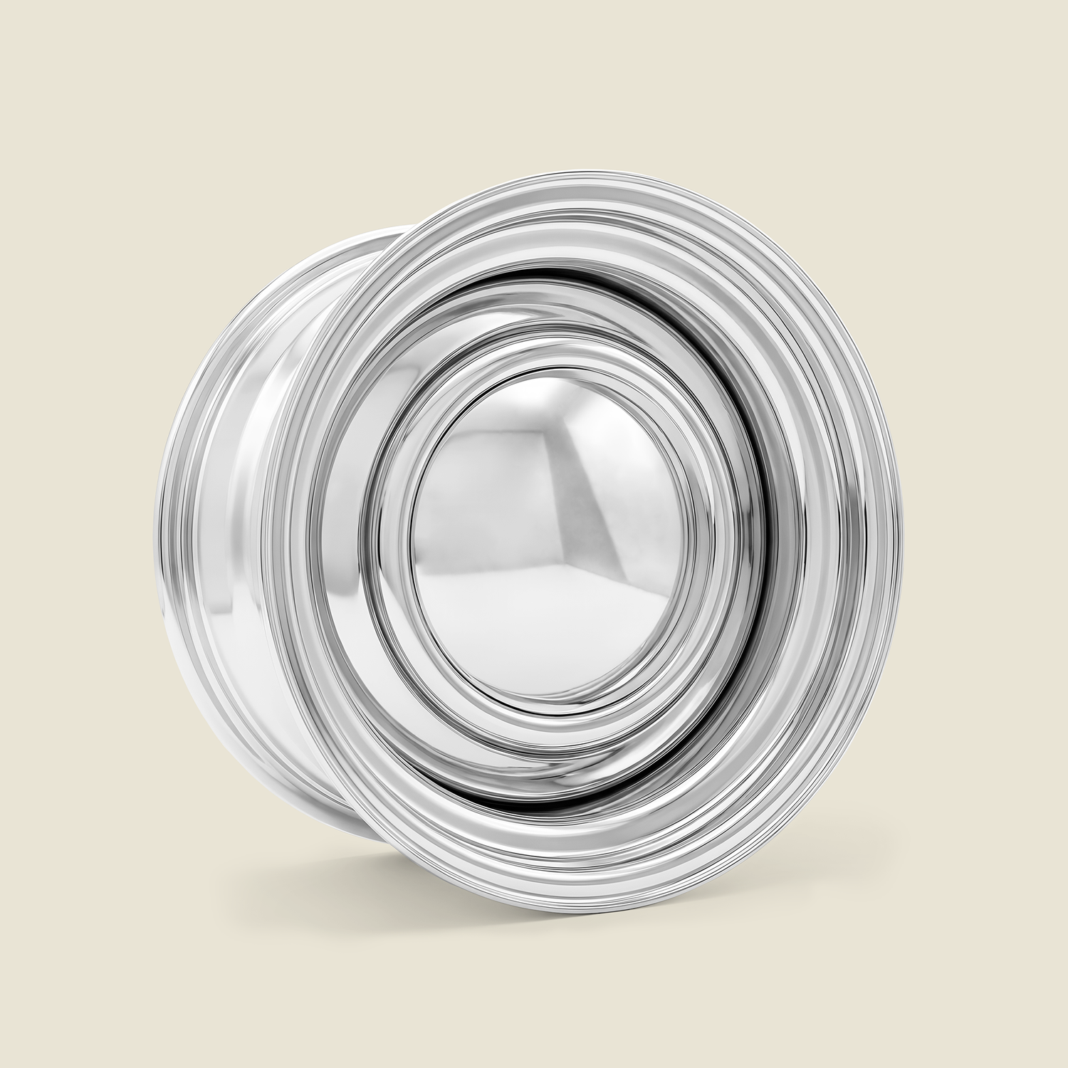 A polished chrome metal wheel rim with a multi-spoke design, shown on a solid light beige background.
